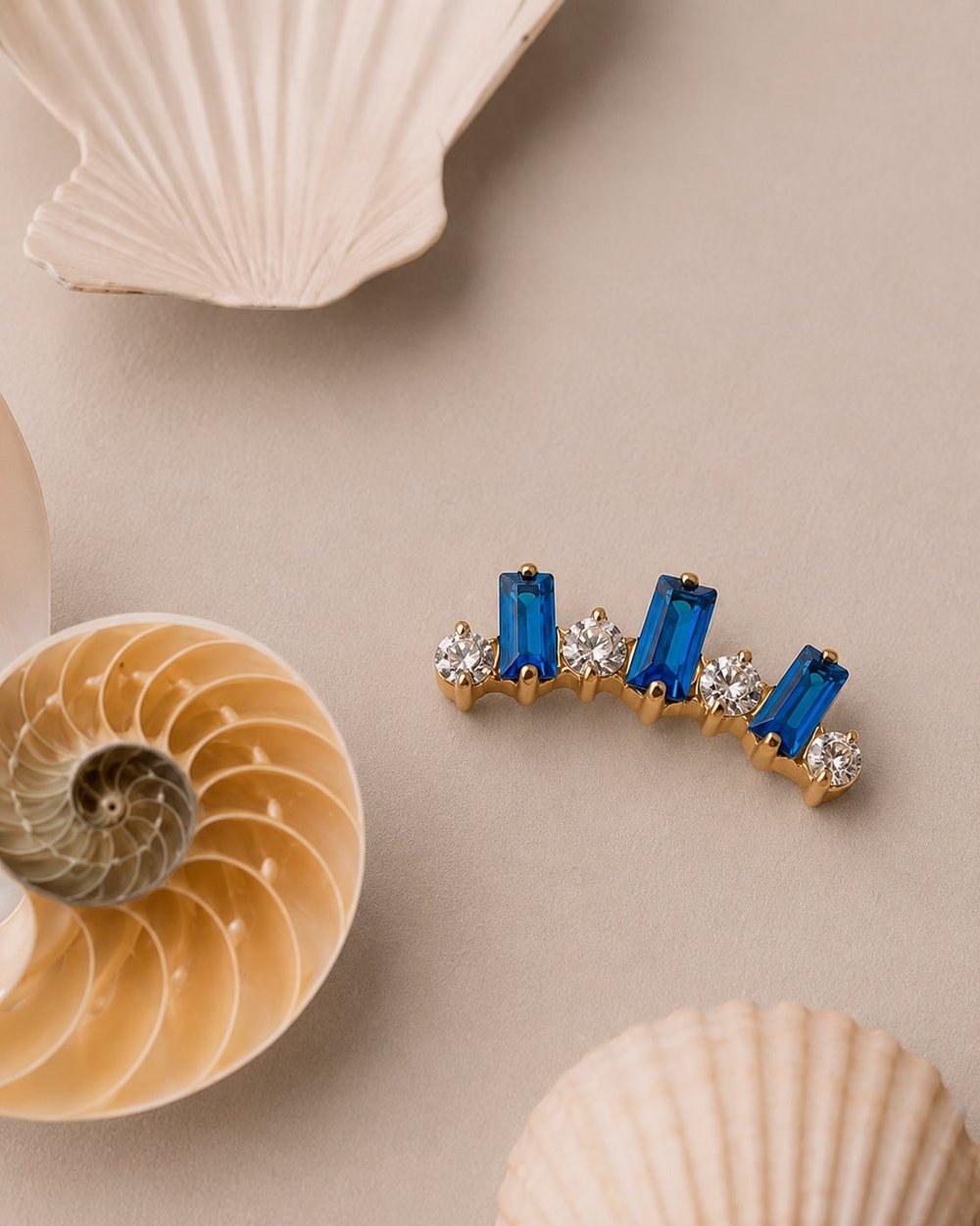 Gold piercing jewelry with blue baguettes and cubic zirconia - Circa Piercing Barcelona
