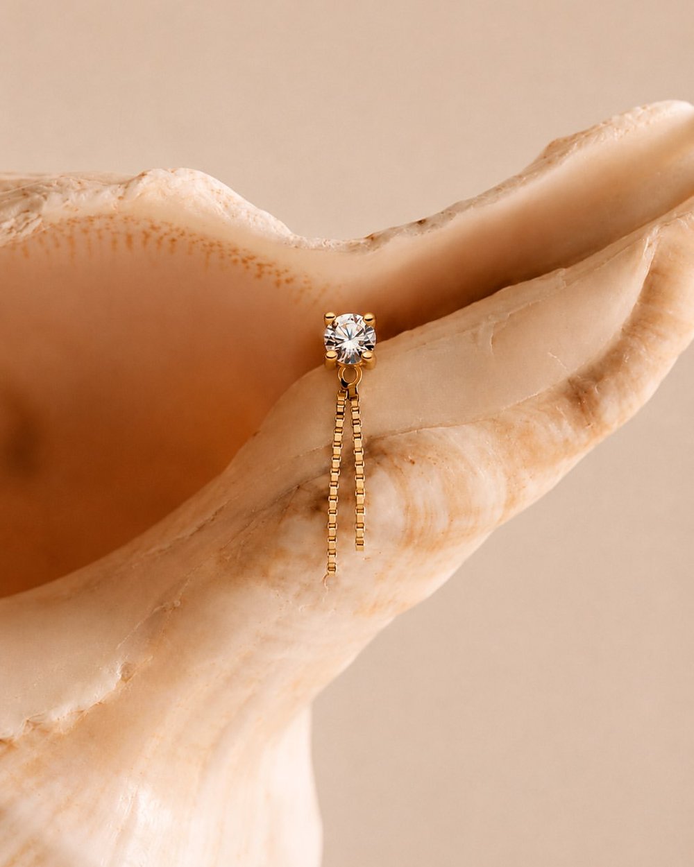Gold piercing jewelry with cubic zirconia and hanging chain - Circa Piercing Barcelona